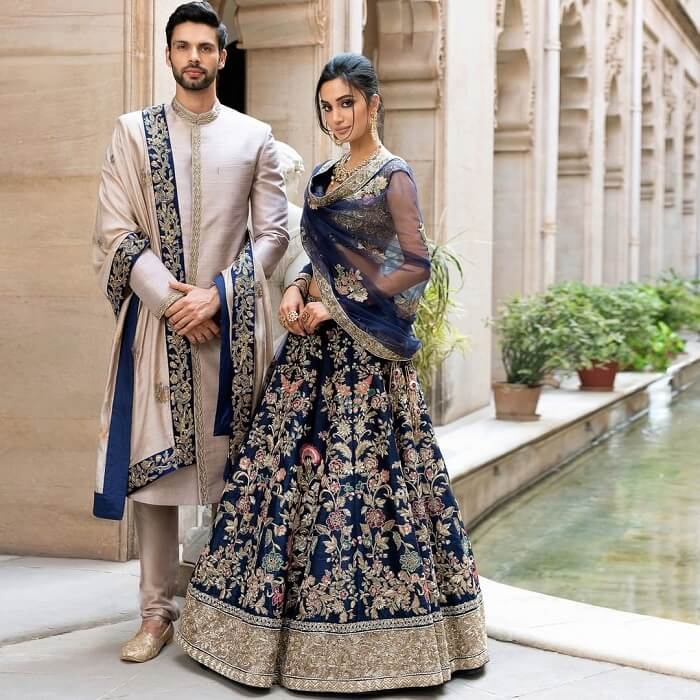 SHYAMAL & BHUMIKA - An ivory raw silk handcrafted lehenga teamed with a  gathered sleeve blouse. . SUMMER COUTURE 2021 Shyamal & Bhumika . Visit Our  Stores! or Shop Online +91-9833520520 (Text,