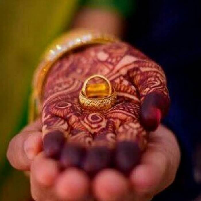 Crop Indian man giving ring to woman during traditional wedding ceremony ·  Free Stock Photo