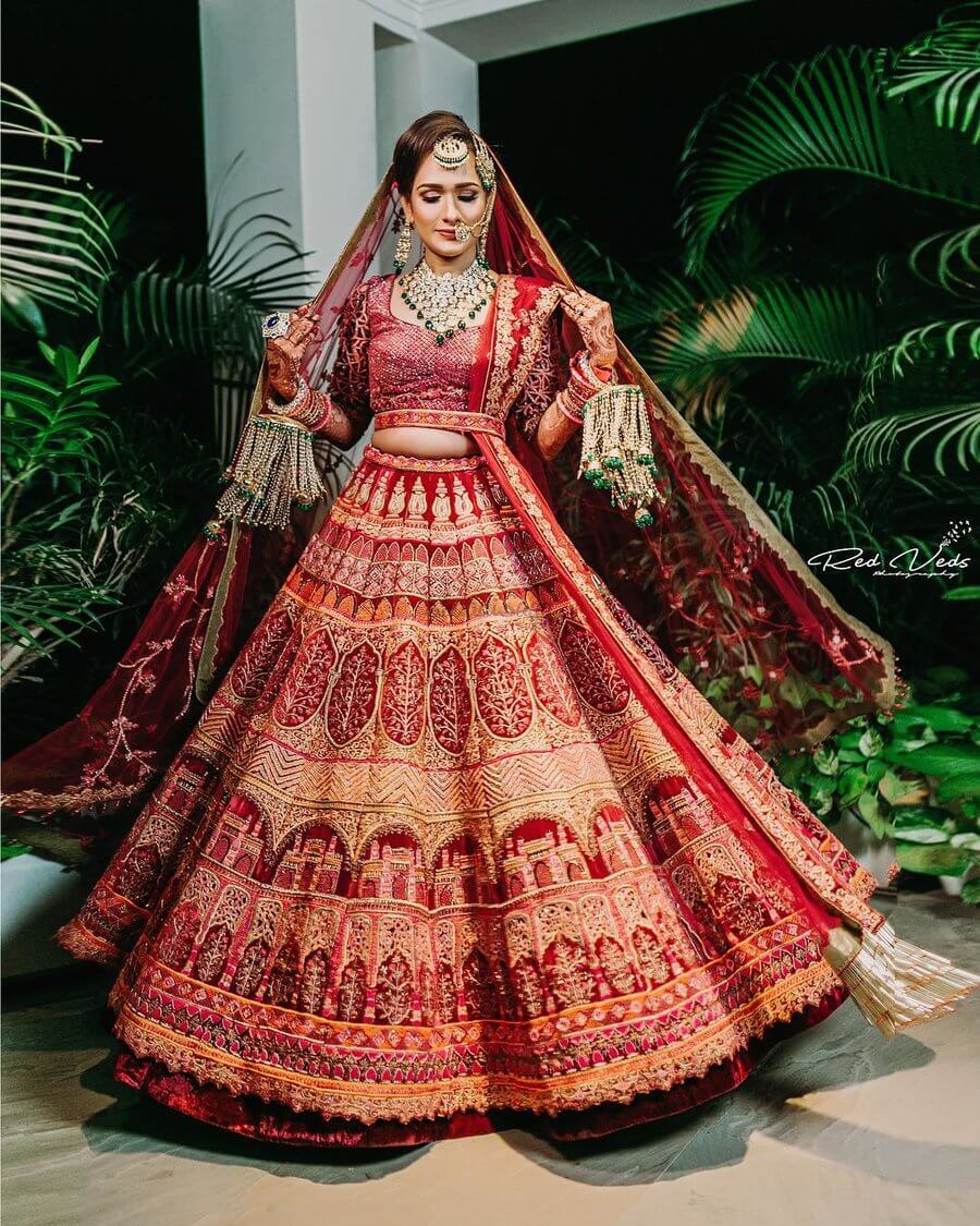 A mesmerizing bridal lehenga choli adorned in deep red, gold and silver  hues. Intricate embellishments and meticulous details create an… | Instagram